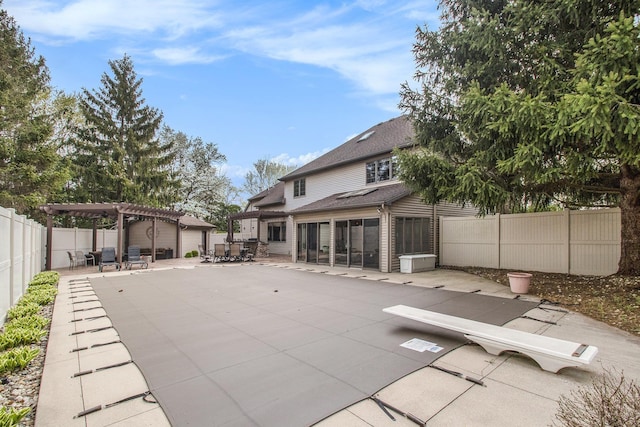 back of property featuring a pergola, a sunroom, a patio, and a fenced backyard