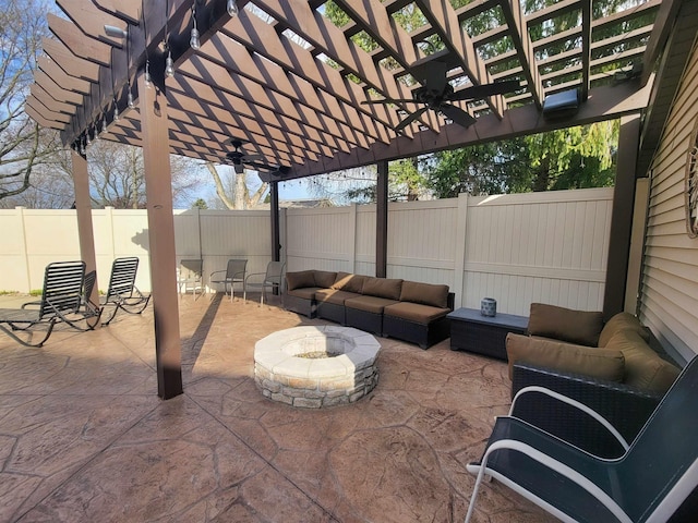 view of patio featuring a pergola, a fenced backyard, a ceiling fan, and an outdoor living space with a fire pit