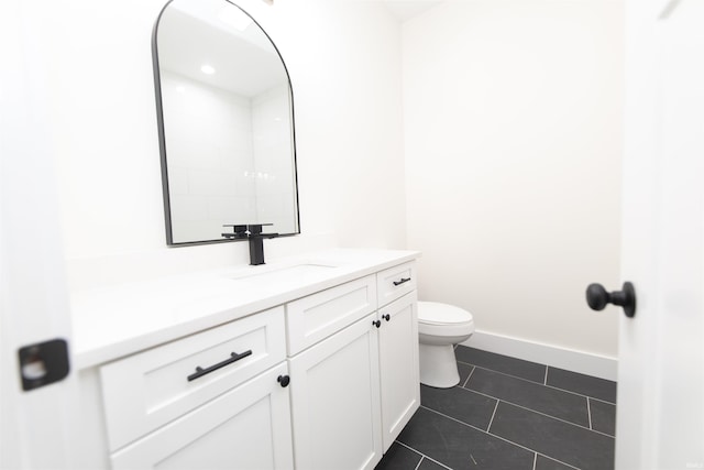 4026 W Carmola Dr, Bloomington, IN 47404 - bathroom featuring baseboards, vanity, tile patterned flooring, and toilet
