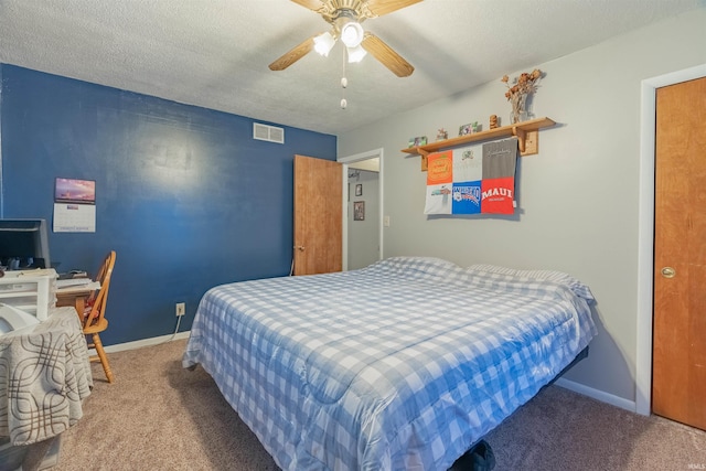 carpeted bedroom featuring baseboards, visible vents, a textured ceiling, and ceiling fan