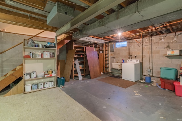 below grade area featuring stairway, washer / clothes dryer, and a sink