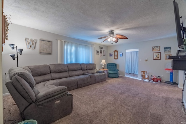 living area with carpet floors, a textured ceiling, and ceiling fan