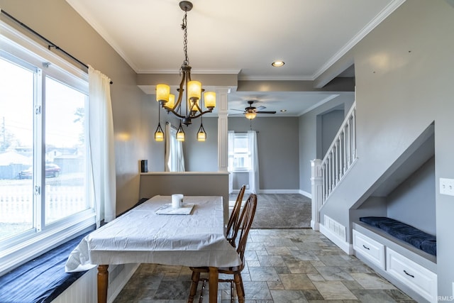 dining room with baseboards, recessed lighting, ceiling fan with notable chandelier, stone finish flooring, and crown molding