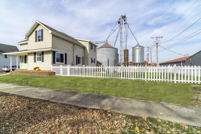 view of front of home featuring fence private yard and a front yard