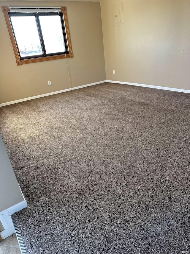 empty room with baseboards and carpet flooring