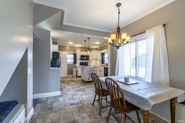 dining area featuring an inviting chandelier, baseboards, stone finish flooring, and ornamental molding