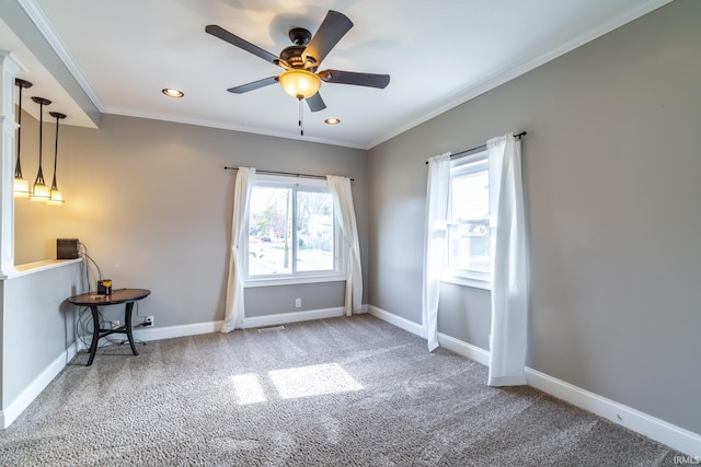 carpeted empty room featuring recessed lighting, visible vents, a ceiling fan, crown molding, and baseboards