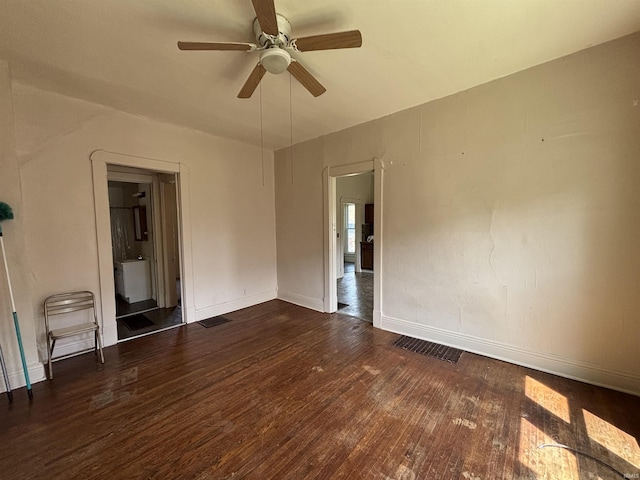 unfurnished room with wood finished floors, visible vents, baseboards, and ceiling fan