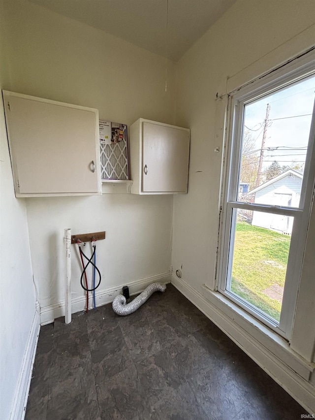 laundry room with cabinet space, washer hookup, and baseboards