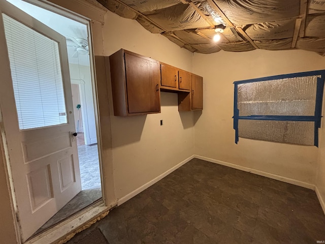 clothes washing area with baseboards