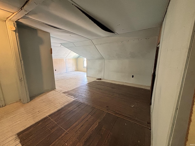bonus room with lofted ceiling and hardwood / wood-style flooring