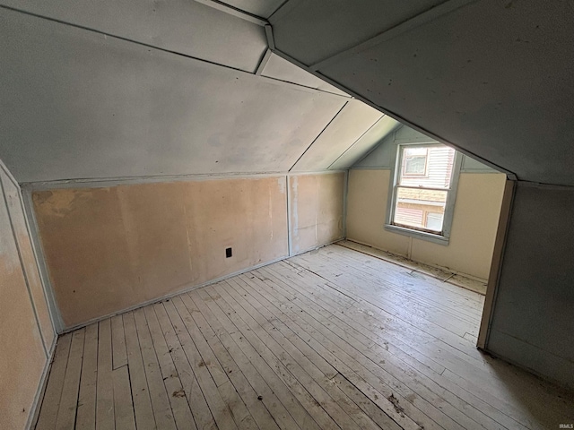 bonus room featuring vaulted ceiling and light wood-type flooring