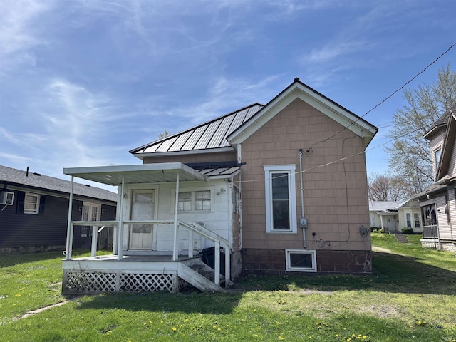 rear view of property with a porch and a yard