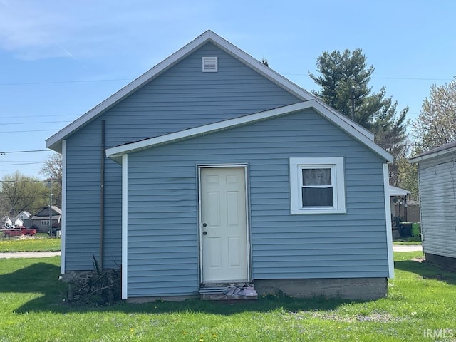 back of property featuring a lawn