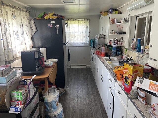 kitchen with white cabinets, dark wood finished floors, freestanding refrigerator, open shelves, and a baseboard radiator