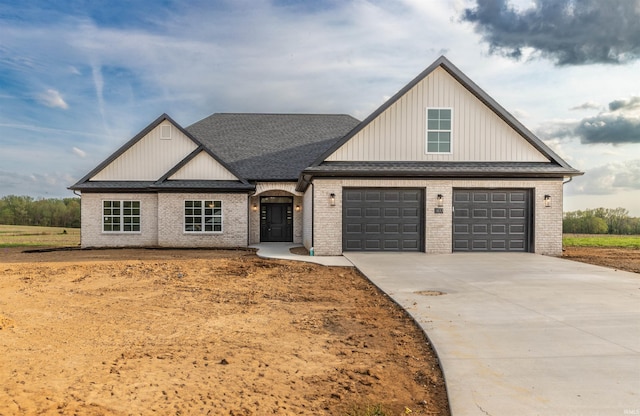 1033 Triple Crown Dr, Evansville, IN 47725 - modern farmhouse style home with concrete driveway, brick siding, roof with shingles, and a garage
