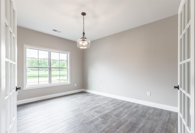 1033 Triple Crown Dr, Evansville, IN 47725 - spare room with visible vents, baseboards, and wood finished floors