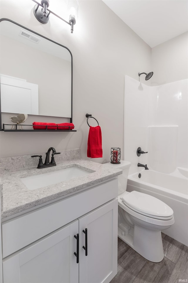 1033 Triple Crown Dr, Evansville, IN 47725 - full bathroom with vanity, toilet, shower / washtub combination, wood finished floors, and visible vents