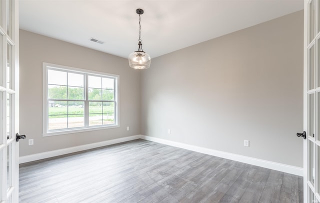 1033 Triple Crown Dr, Evansville, IN 47725 - unfurnished room featuring baseboards, visible vents, and wood finished floors