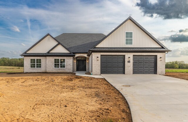 1033 Triple Crown Dr, Evansville, IN 47725 - modern farmhouse style home with concrete driveway, brick siding, roof with shingles, and a garage