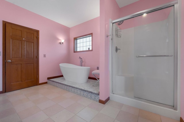 full bath featuring baseboards, a shower stall, and a freestanding bath