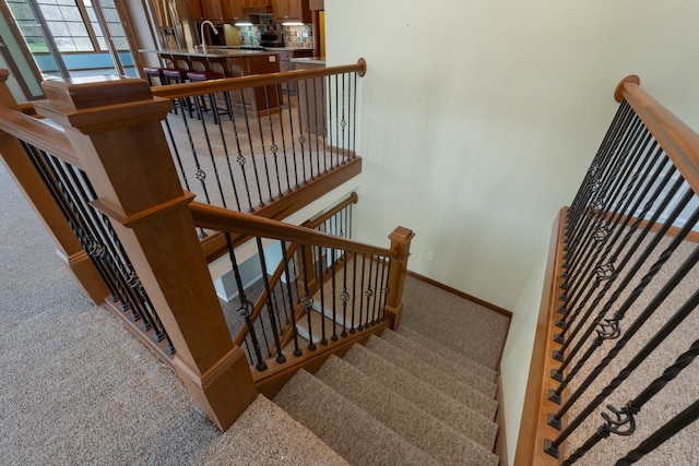 stairs with carpet floors and baseboards