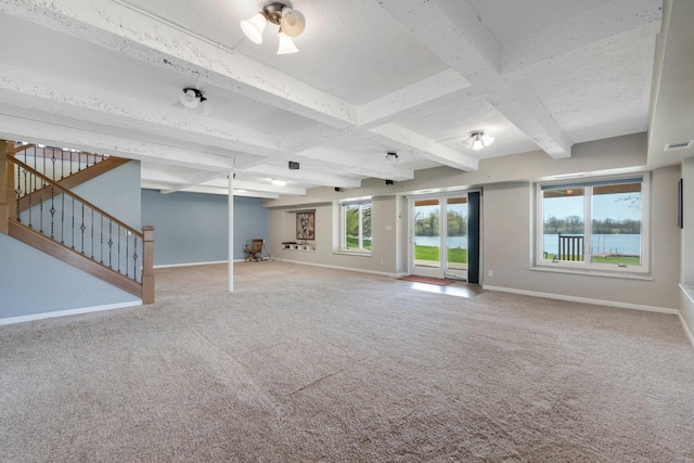 unfurnished living room featuring baseboards, carpet flooring, and stairs