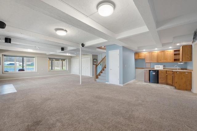 unfurnished living room with stairway, coffered ceiling, beamed ceiling, baseboards, and light colored carpet