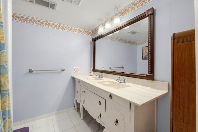 bathroom featuring visible vents, a sink, and double vanity