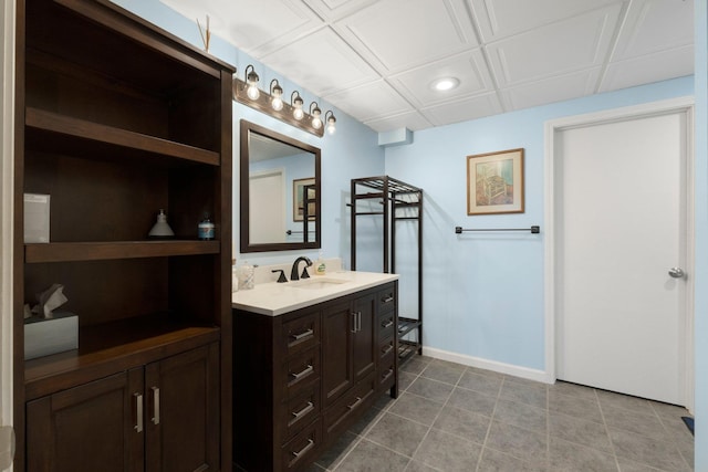 bathroom with recessed lighting, baseboards, tile patterned floors, and vanity