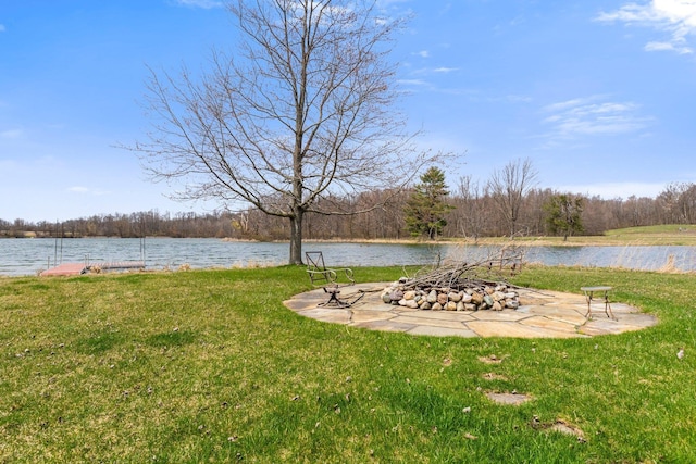 view of yard featuring an outdoor fire pit and a water view