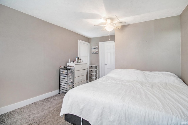 bedroom with light carpet, a ceiling fan, and baseboards
