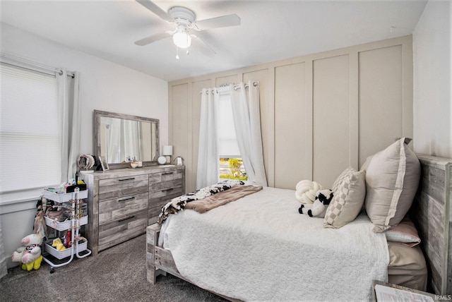 carpeted bedroom with a decorative wall and ceiling fan
