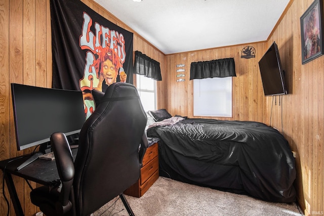 carpeted bedroom with wood walls and ornamental molding