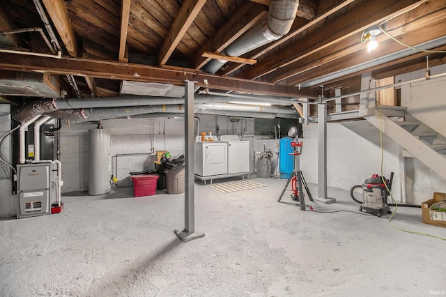 unfinished below grade area featuring separate washer and dryer, heating unit, water heater, and stairs