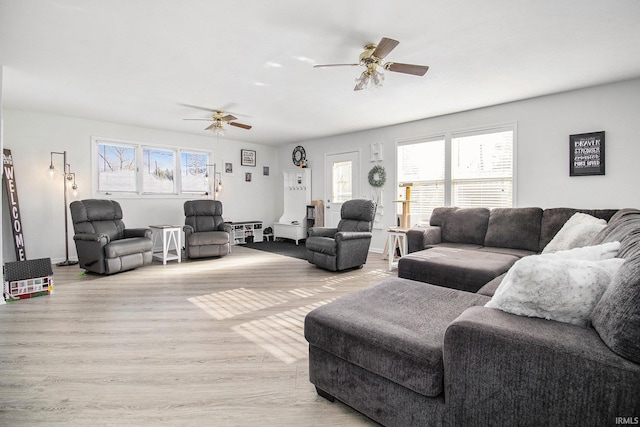 living room featuring light wood-style floors and ceiling fan