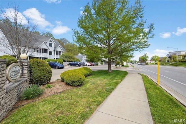 exterior space featuring a residential view, sidewalks, and street lighting