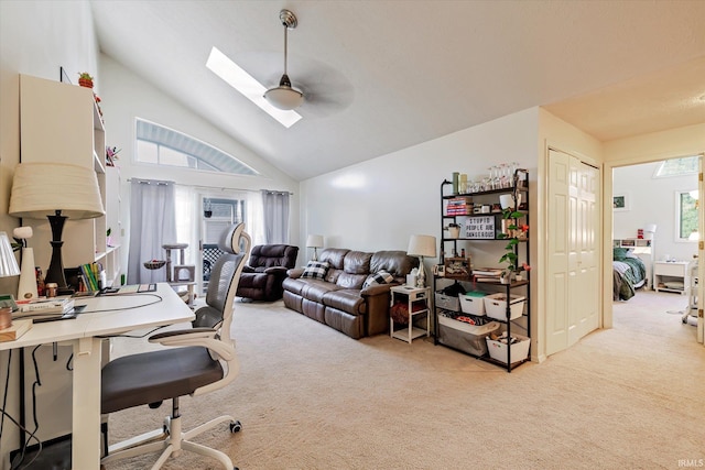 carpeted office with a ceiling fan, high vaulted ceiling, and a skylight