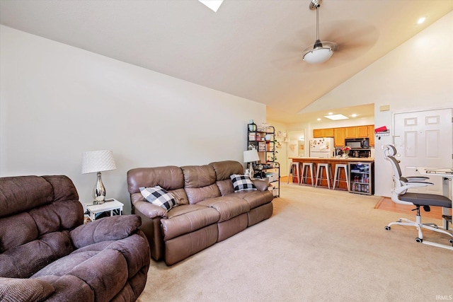 living room with light colored carpet, ceiling fan, and high vaulted ceiling
