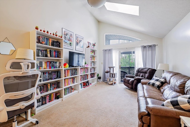 interior space with carpet flooring, high vaulted ceiling, and a skylight