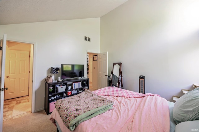 bedroom featuring light colored carpet, high vaulted ceiling, visible vents, and baseboards