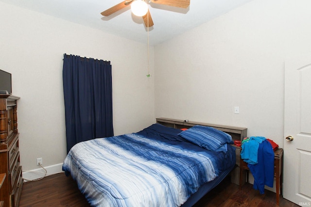 bedroom featuring ceiling fan, baseboards, and wood finished floors