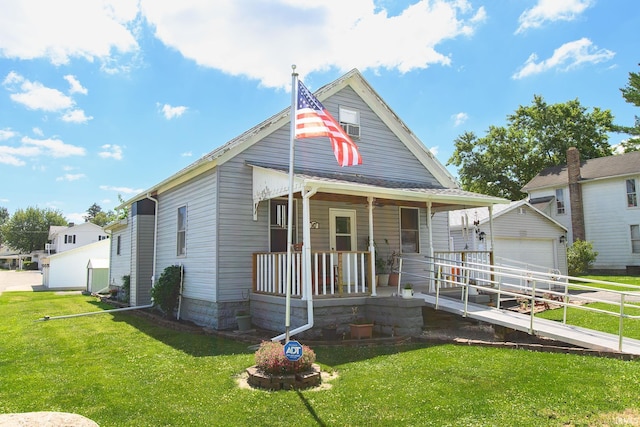 view of front facade with a porch, an outdoor structure, a front yard, and a garage