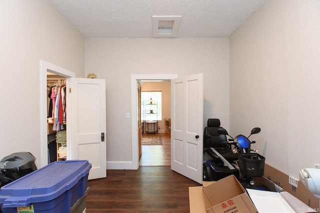 interior space with a textured ceiling and dark wood finished floors
