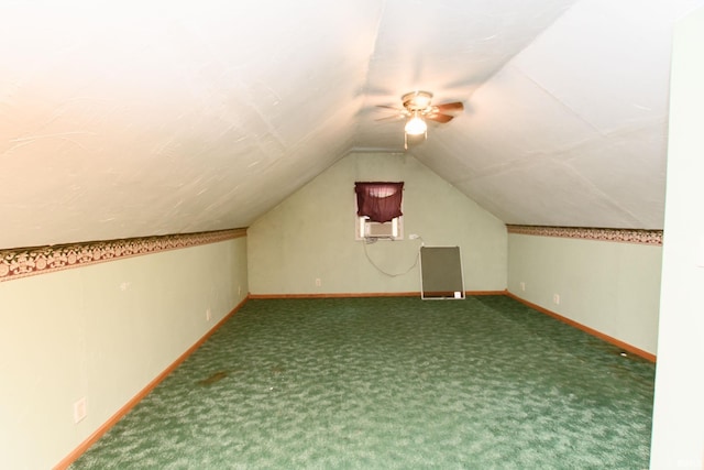 additional living space with vaulted ceiling, carpet flooring, a ceiling fan, and baseboards