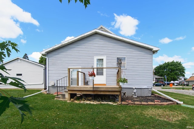 rear view of house with a yard and a deck