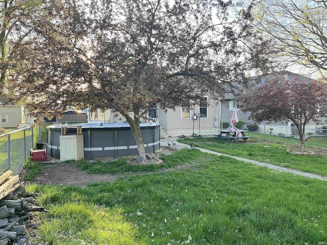 view of yard featuring a fenced in pool and fence