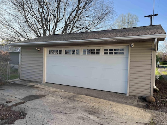 garage with fence and driveway