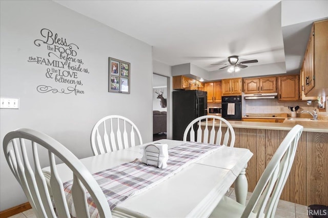 dining space with ceiling fan and light tile patterned flooring