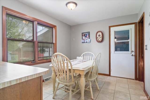 dining space with visible vents, baseboards, and light tile patterned flooring